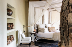 singita_boulders_lodge_river_suite_bedroom_with_white_chair_adriaan_louw Sabi Sand Lodges - Umkumbe Safari Lodge